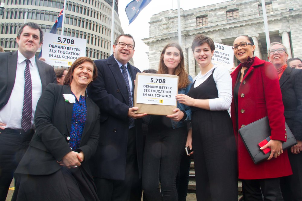 Lauren and Ruby handing over their petition to Grant Robertson and Jenny Salesa outside Parliament
